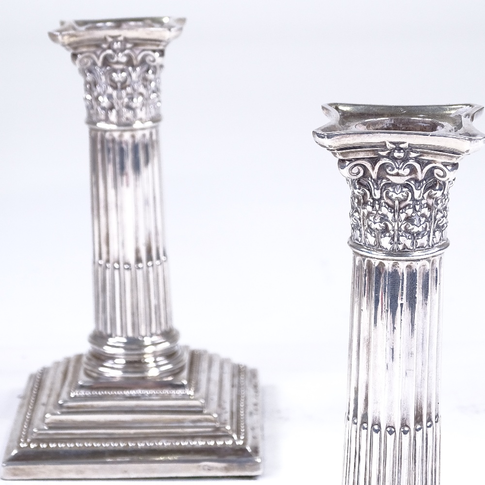 A pair of late Victorian squat silver Corinthian column candlesticks, by Walter Latham & Son,