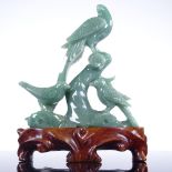 A Chinese jadeite carving, depicting 3 exotic birds, on hardwood stand, height 20cm The largest bird
