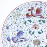 A Chinese porcelain bowl with painted polychrome dragon designs, 6 character mark, diameter 24cm