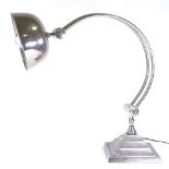 A large aluminium Art Deco style table lamp, with curved support on square base, base 25cm across,