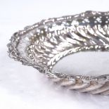 A late Victorian circular silver sweet meat dish, half-fluted form with foliate and pierced