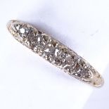An early 20th century 18ct gold graduated 5-stone diamond half hoop ring, total diamond content