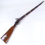 An Antique percussion muzzle loading rifle