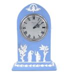 A Wedgwood blue Jasperware lancet-top mantel clock, movement by Baronet of London, case height 19.