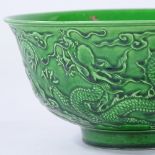 A Chinese green glaze porcelain bowl, with relief moulded dragons, 6 character mark, diameter 16cm