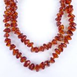 A graduated string of amber beads, individually knotted, necklace length 72cm, 26.8g Excellent