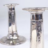 A pair of George V silver squat candlesticks, tapered octagonal form with Adams style decoration, by