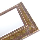 An Islamic micro-mosaic and ivory inlaid cushion-framed mirror, with inset bevelled glass, the
