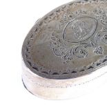 A George III silver nutmeg grater, oval form with bright-cut floral engraved decoration and hinged
