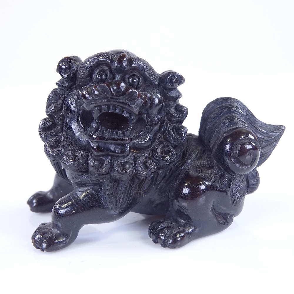 A Japanese carved and stained wood Dog of Fo design netsuke, signed, length 6cm