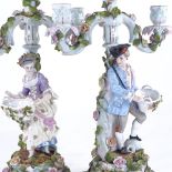 A pair of Continental porcelain 3-branch candelabra, supported by country figures, height 42cm No