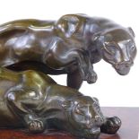 An Art Deco period patinated bronze group of 2 prowling panthers, on original amboyna plinth,