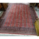 A large Persian handmade red ground geometric design wool rug