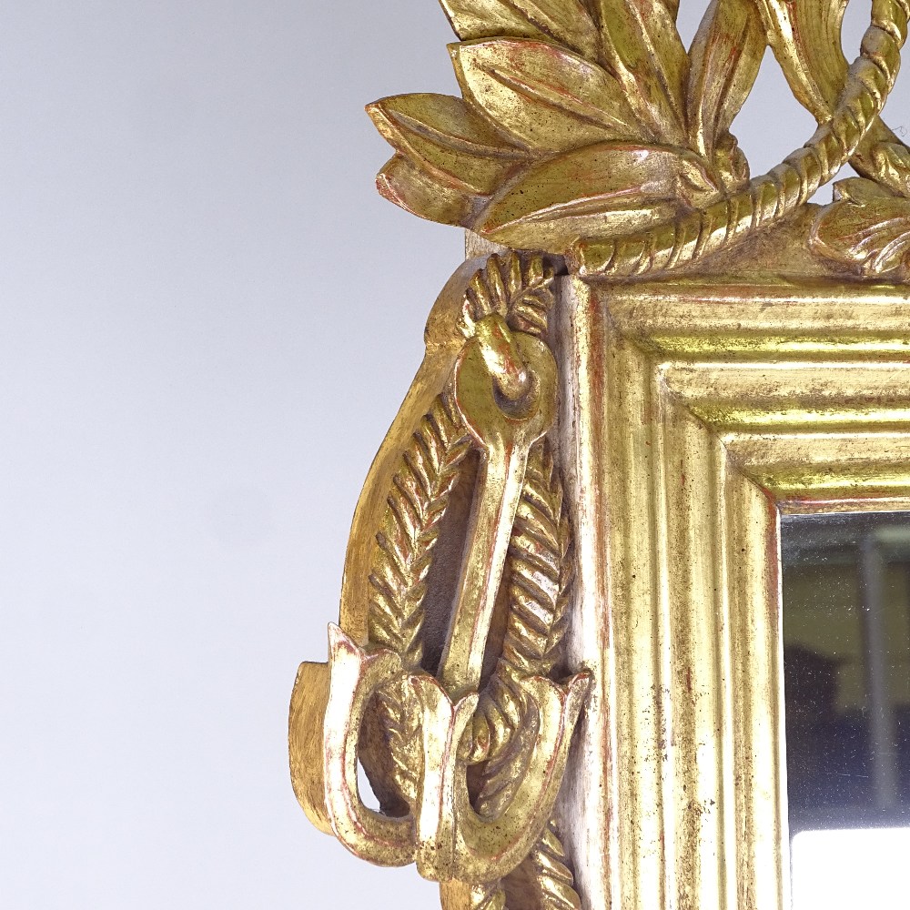 An ornate carved and gilded wood-framed wall mirror in Louis XVI style, with carved and pierced - Image 3 of 3