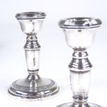 A pair of George VI silver squat candlesticks, tapered form with reeded decoration, by W I