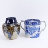 A large 19th century blue and white transfer pottery loving cup, height 15cm, and a Royal Doulton