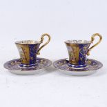 A pair of Russian blue and gilt porcelain cabinet cups and saucers, with hand painted panels