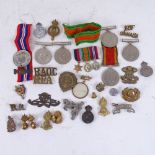 Various Second War Defence and Campaign medals, military cap badges, brooches etc