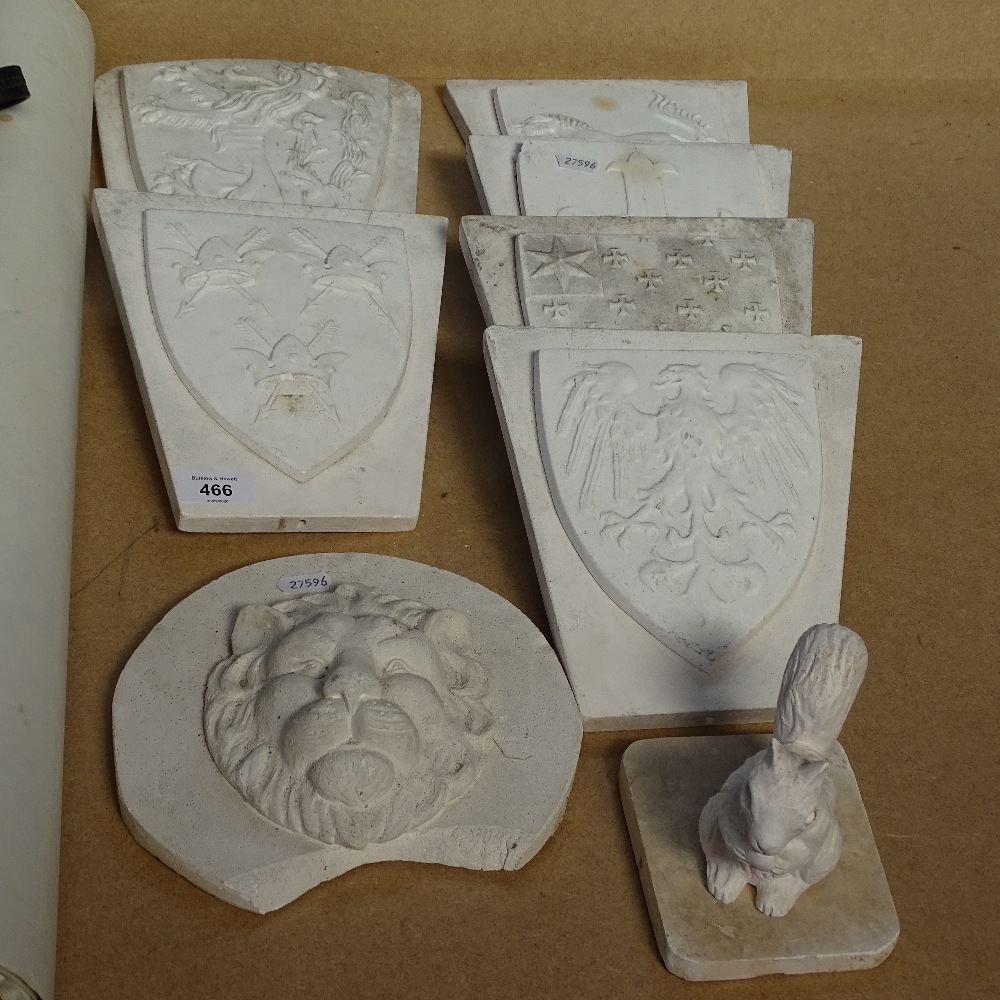 7 plaster heraldic plaques, largest 30.5cm, and a squirrel