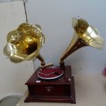 A reproduction Victrola twin brass-horn gramophone, base width 45cm