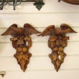 An opposing pair of carved pine eagle wall brackets, height 33cm