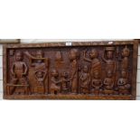 A carved wood frieze depicting African musicians and family, length 1m