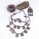 An Eastern coral and unmarked white metal betel box, enamelled tassel pendant, coin necklace and