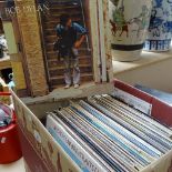 A box of Vintage LPs, including Moody Blues, Phil Collins, and Bob Dylan