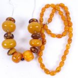 A graduated string of large simulated polished amber beads, largest bead length 39.8mm, and a string