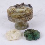 A Chinese relief carved jade box and cover, diameter 8cm, and 2 relief carved jade pendants (3)