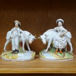 A pair of Staffordshire porcelain figures, farmer and wife with cattle, height 18cm