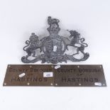 A cast-brass Royal coat of arms, length 29cm, and 2 brass County Borough of Hastings plaques