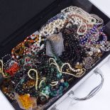 A case containing bead necklaces, including jade, coral etc