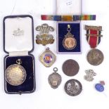 Various early 20th century medals and badges, including some silver and the Welch Regiment