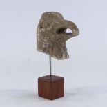 A carved stone eagle's head mounted on wood stand, overall height 25cm