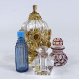 An ornate gilt-metal and glass perfume bottle, height 12.5cm, and 3 smaller glass perfume bottles