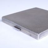 A George V Art Deco square silver cigarette case, allover engine turned decoration, with concealed