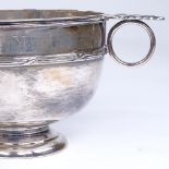 A George V circular silver 2-handled porringer, cast acanthus leaves with cross reeded decoration,