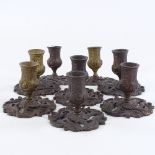 A set of 8 French patinated bronze candlesticks, late 19th/early 20th century, height 9cm, base