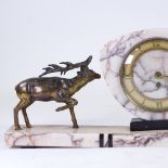 An Art Deco pink veined marble 30-hour mantel clock, surmounted by 2 spelter stags, with brass