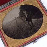 A 19th century early photograph, portrait of a man with a penny farthing bicycle, in original