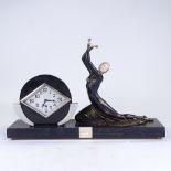 An Art Deco slate and white onyx 30-hour mantel clock, silver diamond-shaped dial with Arabic