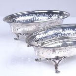 A pair of George V oval silver bon bon dishes, pierced friezes with scrolled floral feet, by