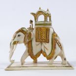 An Indian ivory caparisoned elephant with gilded decoration, height 8cm, length 9cm Gilding