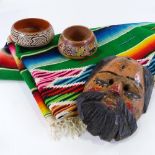 A large hand woven Mexican Saltillo Serape (blanket), a carved and painted wood mask, a pair of