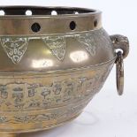 A Chinese polished bronze jardiniere, with relief moulded frieze, elephant ring handles and 3