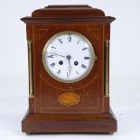 An early 20th century French mahogany-cased 8-day mantel clock, white enamel dial with Roman numeral