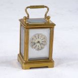 A miniature brass-cased carriage clock, printed dial with Roman numeral hour markers and silvered