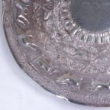 A Sri Lankan unmarked silver presentation salver, allover relief embossed animal and floral