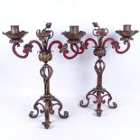 A pair of painted and gilded wrought-iron candelabra with floral decoration, 43.5cm